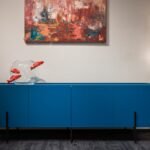aquarium stand with fish tank — Modern blue cupboard with glass aquarium decorated with fish placed at white wall with creative picture in modern room with glowing lamps