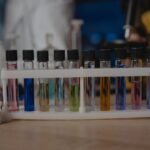A row of liquid aquarium test kit vials with colored solutions, illustrating water testing for aquariums.