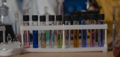 best liquid aquarium test kit — Close-up of test tubes with colored liquids in a laboratory setting.