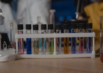 best liquid aquarium test kit — Close-up of test tubes with colored liquids in a laboratory setting.