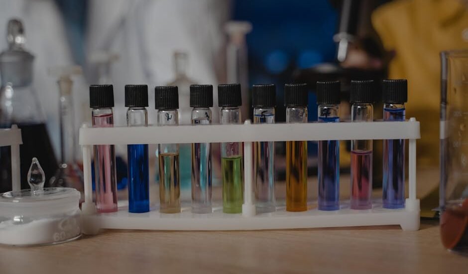 best liquid aquarium test kit — Close-up of test tubes with colored liquids in a laboratory setting.