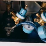 Close-up of aquarium CO2 regulators with blue dials and gauges, illustrating equipment reviewed for planted tanks.