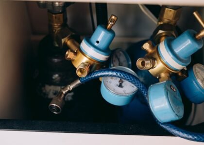 Close-up of aquarium CO2 regulators with blue dials and gauges, illustrating equipment reviewed for planted tanks.