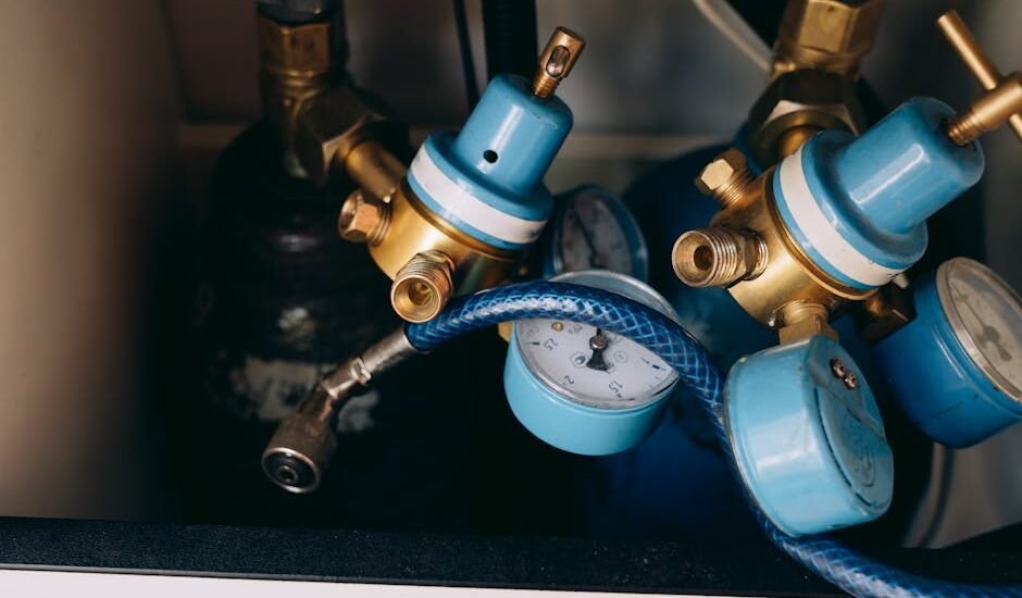 Close-up of aquarium CO2 regulators with blue dials and gauges, illustrating equipment reviewed for planted tanks.