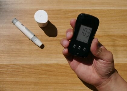 A hand holding a digital pH meter alongside a manual pH testing kit, illustrating the difference between the two types.