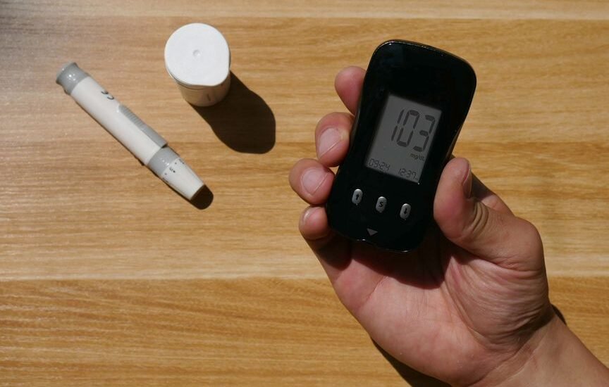 A hand holding a digital pH meter alongside a manual pH testing kit, illustrating the difference between the two types.