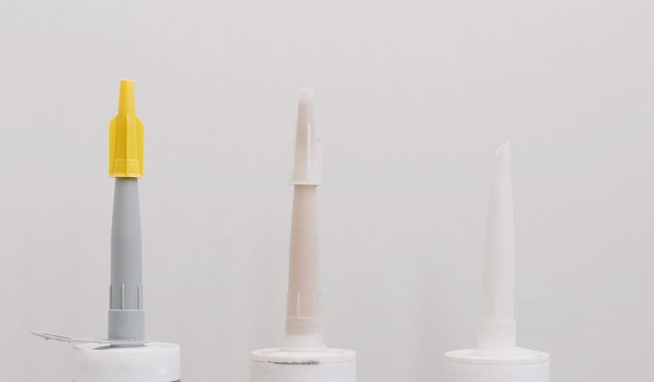 Three tubes of silicone sealant, relevant for removing old silicone from aquariums.