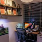 A home office featuring a planted aquarium and workspace, relevant to using root tabs.