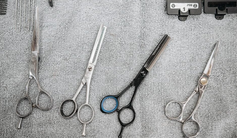 Scissors and grooming tools laid out on a towel for disinfecting aquarium tools.