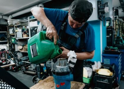 A person pouring water into a canister filter, illustrating how to prime a canister filter.