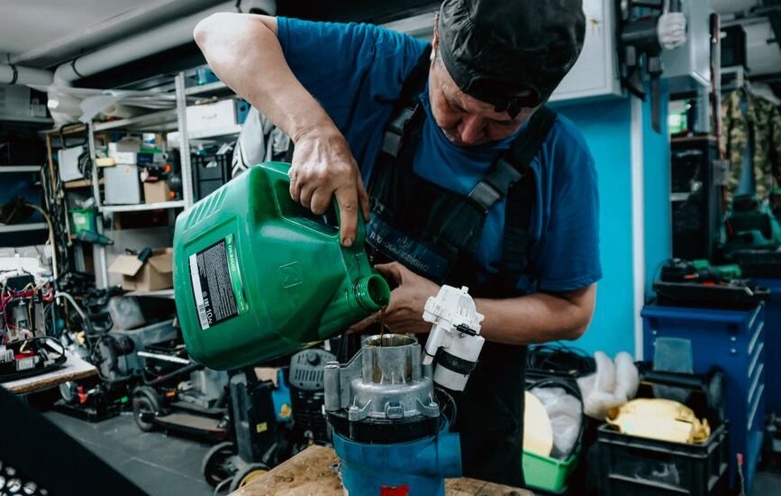 A person pouring water into a canister filter, illustrating how to prime a canister filter.